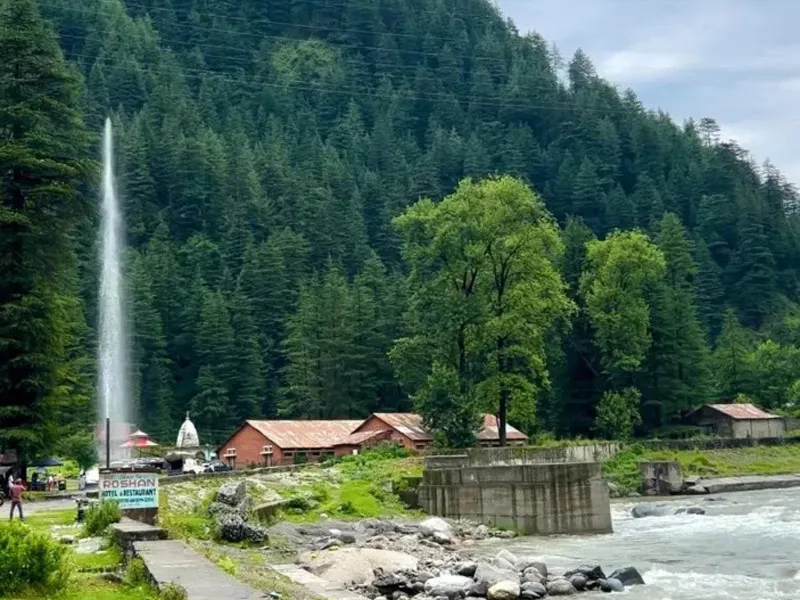 Scenic Shaan-e-Barot high water fountain shooting upwards by the Uhl River amidst dense cedar woods