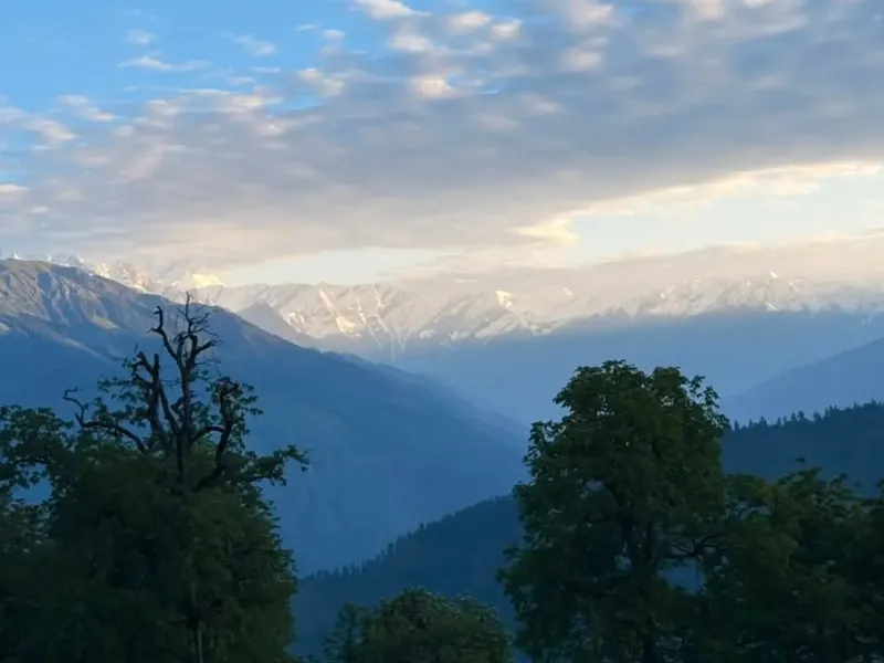 Panoramic view of layered Himalayan mountain ranges under morning light