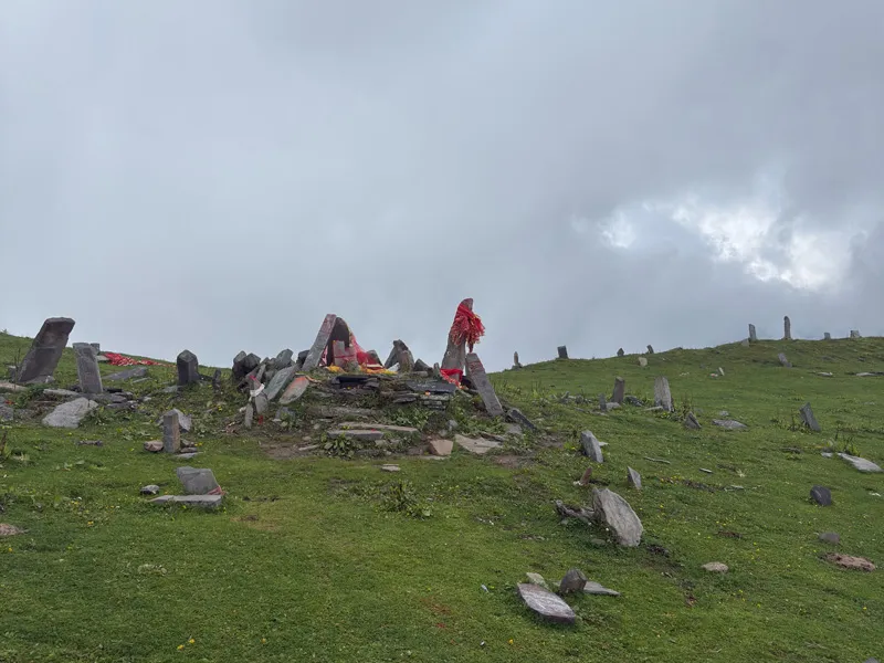 Sacred stone shrine and prayer flags on the mountain crest of Chandrakhani Pass
