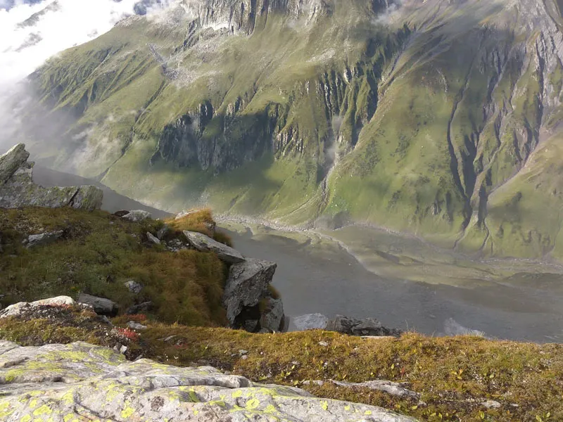 Stunning aerial view of a rugged green mountain gorge and alpine valley