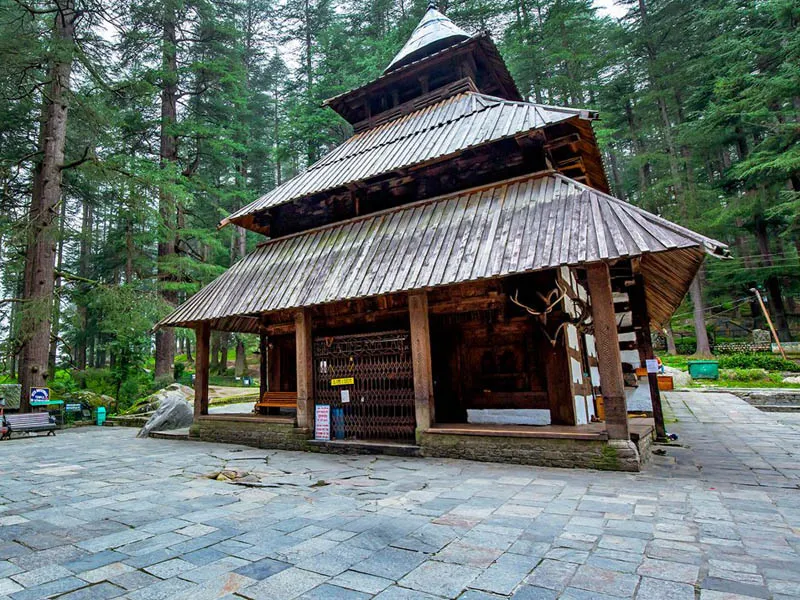 Historic multi-tiered wooden pagoda architecture of Hadimba Temple surrounded by deodars in Manali