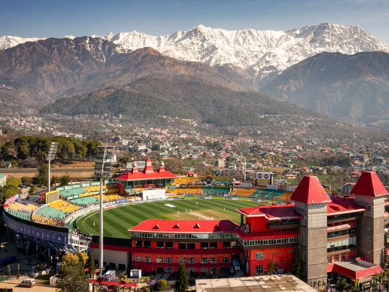 Aerial view of HPCA Cricket Stadium in Dharamshala with the snow-covered Dhauladhar mountain peaks in the background