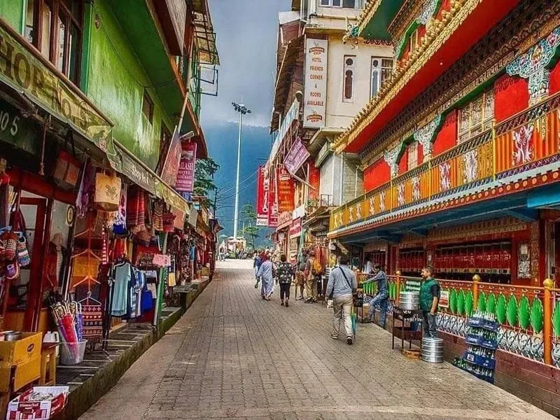 Paved street with vibrant handicraft shops and colorful buildings in McLeodganj market Dharamshala