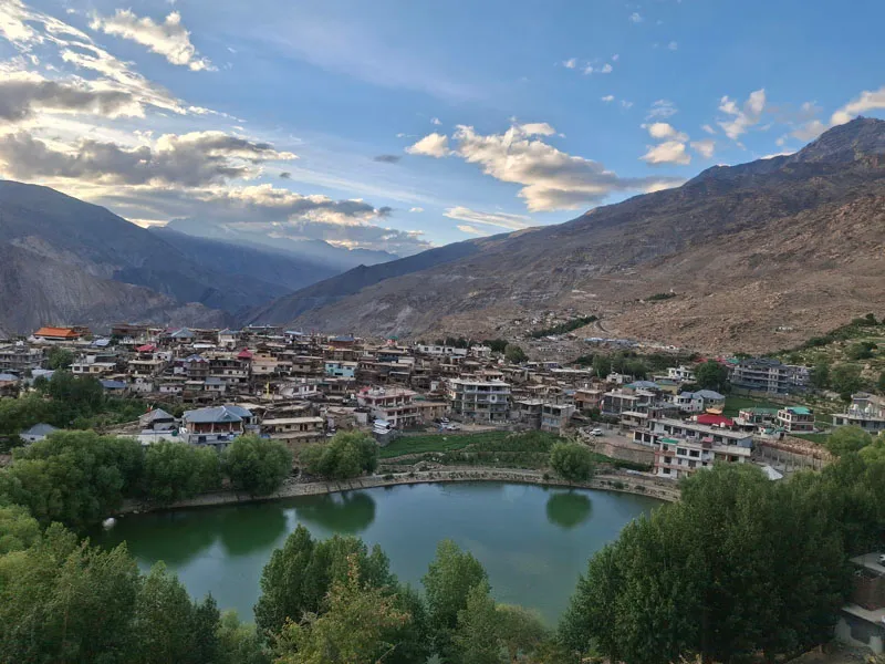 Elevated panoramic view of Nako village and sacred Nako Lake framed by barren mountain slopes