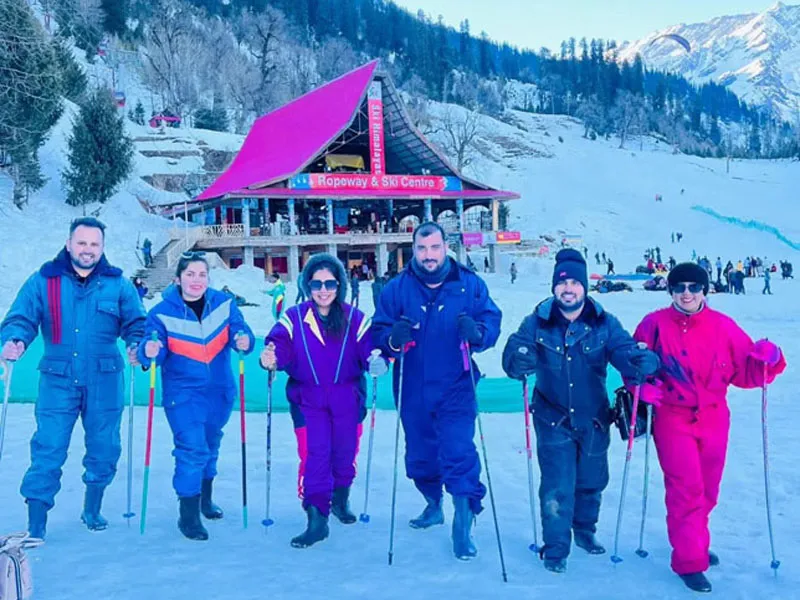 Tourists enjoying snow adventures and skiing in colorful snow suits