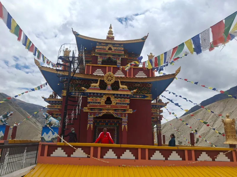 Colorful Buddhist monastery building draped with traditional prayer flags in Spiti