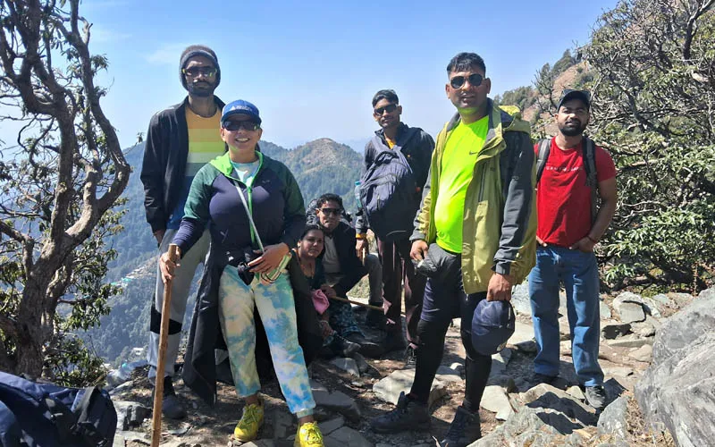 Trekkers standing together on a rocky mountain path on the way to Laqa Glacier