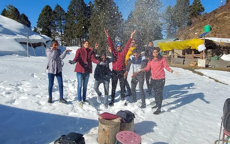 Group of cheerful tourists posing outdoors on a sunny day in Himachal Pradesh