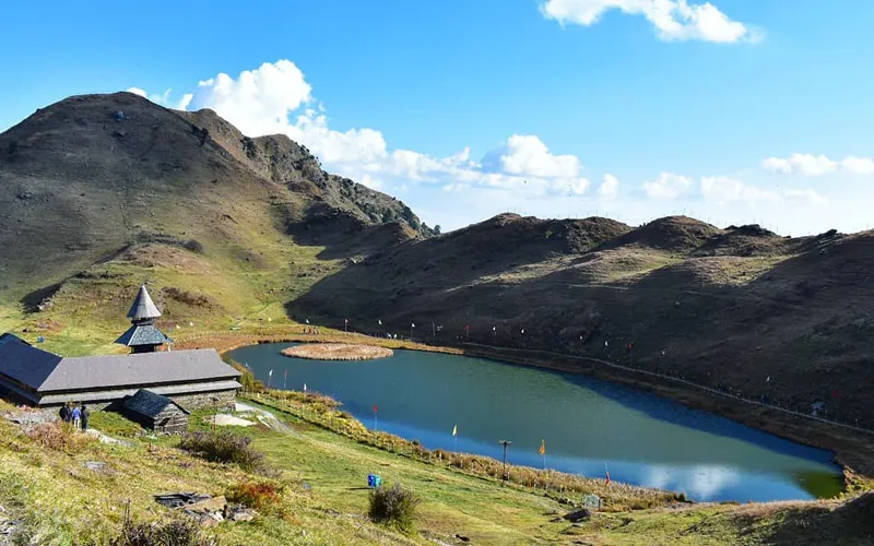 Scenic Prashar Lake with traditional pagoda style temple on rolling green meadows